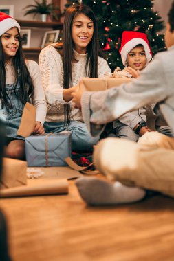 Çok kültürlü aile hediyelerini paylaşıyor ve Noel 'i ve Noel' i evde kutluyorlar..