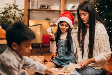 Mutlu bir aile Noel 'de evde otururken Noel hediyeleri hazırlıyor..