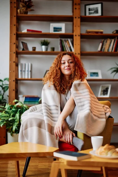 Happy Redhead Girl Covered Blanket Sitting Her Armchair Living Room — Stockfoto