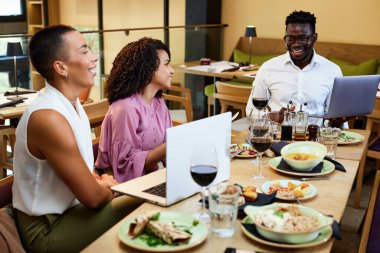 İş adamları bir restoranda yemek masasında oturup bir başlangıç projesi hakkında beyin fırtınası yapıyorlar..