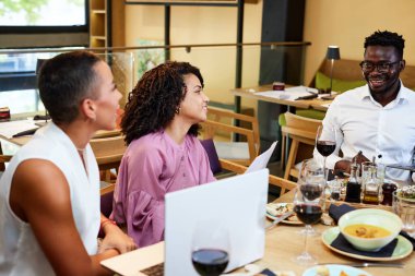 Businesspeople have team building in a restaurant during lunch.