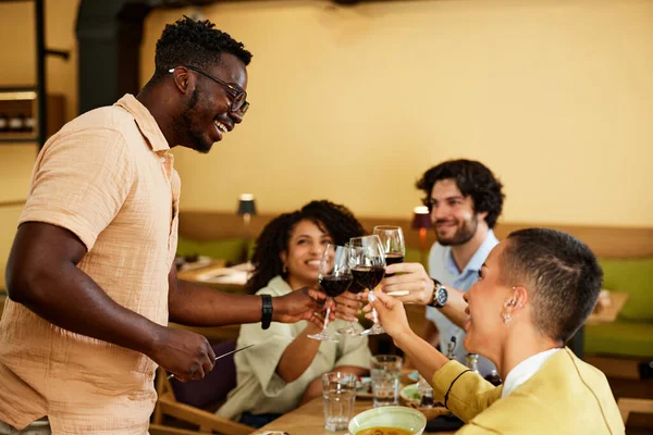 Happy Multiracial Friends Sit Restaurant Celebrate Happy Event Toasting Red — Stockfoto