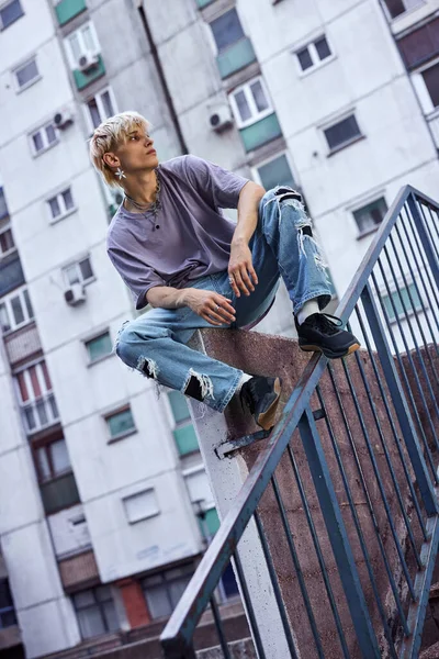 Teenage Boy Sits Concrete Wall Urban Exterior Looking Away Feeling — Fotografia de Stock