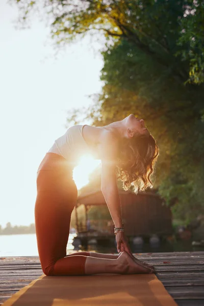 Fit Middle Aged Woman Practicing Yoga Dock Sunset She Camel — ストック写真