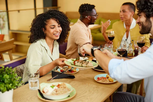 Hispanic Girl Sharing Food Plate Her Friends Dinner Table Restaurant — 스톡 사진