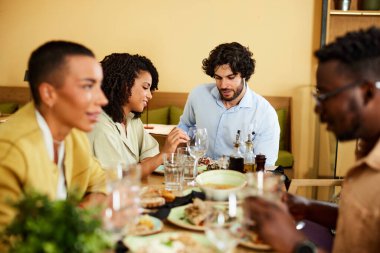 A Group of friends has dinner together in a restaurant.