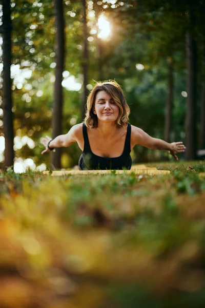 Yogi woman practicing yoga in nature in the forest.