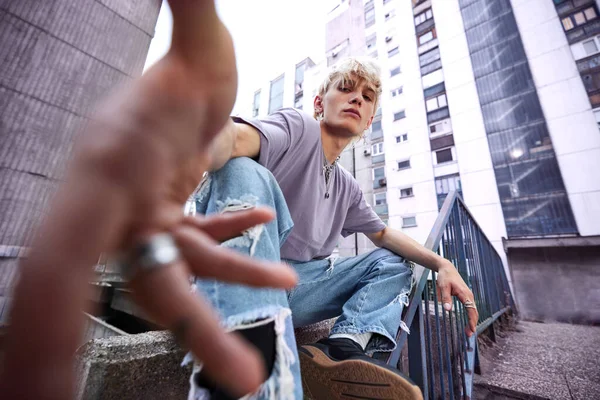 Close Teenage Boy Reaching Camera While Crouching City Street — Stockfoto