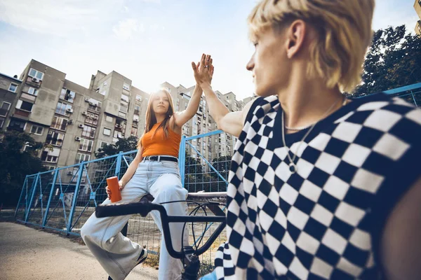 Teenage Couple Giving High Five Each Other While Sitting Urban — Stock fotografie