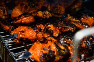 Delicious Grilled Tandoori of Assorted Meats over Charcoal and hot grill on Skewers.