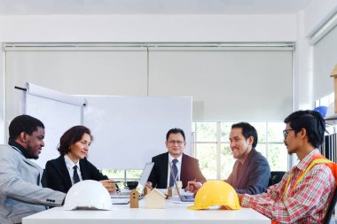 Five engineer business people discussing while sitting at meeting table in office together, multi-ethnic colleagues team working at the workplace, variety worker ethnic group do brainstorm meeting.