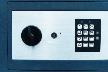 Fragment of a safe with a code panel and a magnetic key. A portable storage box made of durable metal for valuables. Flat frame