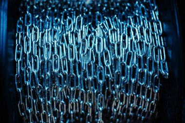 Stainless steel chain wound on a large bobbin. Close-up