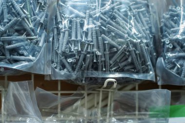 Dowels and screws in plastic packaging. Close-up