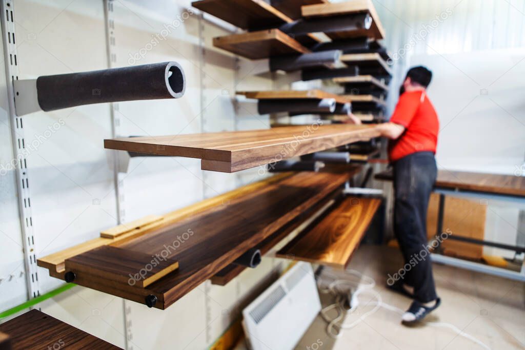 Furniture manufacturing. Veneer parts in a drying chamber after varnishing. Unrecognizable people. Selective focus