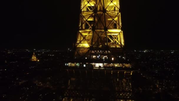 Static drone shot of a restaurant on the Eiffel Tower at night. — стокове відео