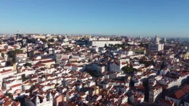 Drone view of the central part of Lisbon with churches and different houses.