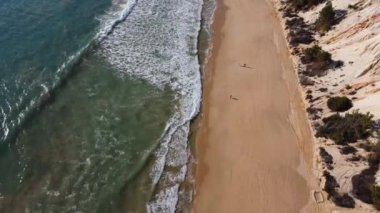 Drone view of the Atlantic Ocean on a large sandy beach in Portugal.