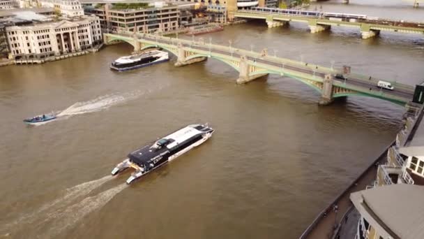 Drone view of floating boats on the river Thames in London with two bridges. — Stock Video