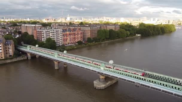 Drone footage of a train from the bridge to Putney Bridge station. — Stock Video