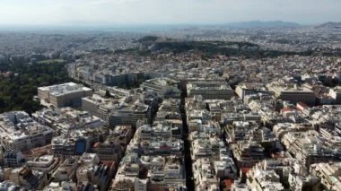 Drone view of the streets of Athens with Mount Lycabettus in the background.