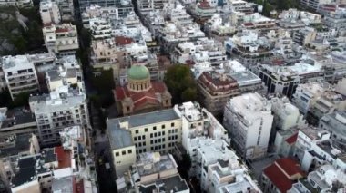 Drone view of a small Orthodox church among the narrow streets of Athens