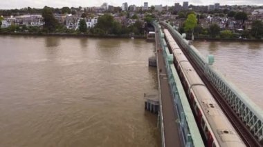 A drone view of a tube train on the Thames Bridge in London