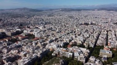 Drone view of the endless quarters of Athens in the rays of the rising sun.