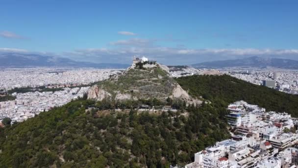 Nagranie z lotu drona góry Lycabettus otoczonej ulicami Aten — Wideo stockowe