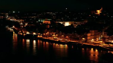 Porto 'nun güzel gece manzarası, nehre yansıyor. Kasım gece geç saatlerde Portekiz 'deki bir gece şehri için genel plan.