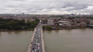 Drone view of the car traffic on the Putney Bridge and the transition of the frame to the Fulham Railway Bridge.