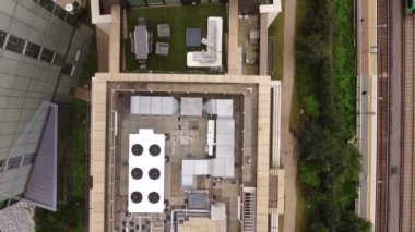 View from a drone on the roof of multi-storey buildings near the railway tracks. Filming 7 Lillie Square near Brompton Cemetery in London.