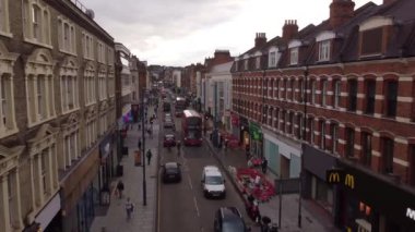 Flight of a drone along the identical brick houses of the street in Putney. Filming in the UK.