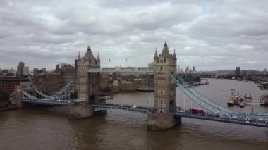 Pleasure boats on the River Thames Drone view of Tower Bridge on a cloudy day. Pleasure boats on the Thames. Filming over the river.