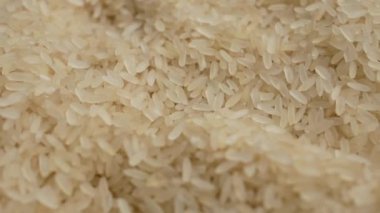 Close-up shot of grains of rice in motion. Texture photography of cereals.