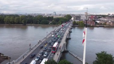 Drone view of Putney Bridge with the British flag at the beginning of the video. Shooting in September in the Putney area of London.