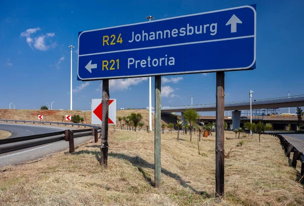 Road signs indicating the direction of travel to Pretoria and Johannesburg at the fork in the road. Road sign indicating the direction of travel by car from Tambo Airport. South Africa,