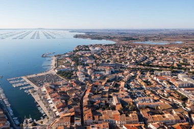 Aerial view of the village of Meze, on a winter morning, in Herault in Occitanie, France
