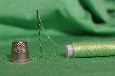 Yeşil İplik, Yüksük ve İğne Makarnası Yeşil Kumaşa Yaklaş