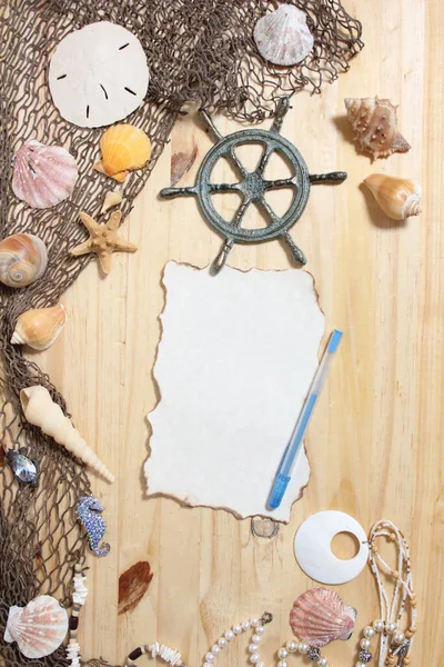 Blank Paper With Burned Edges on Wood Background With Sea Shells and Fishing Net. Nautical and Coastal Theme