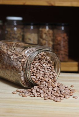 Bir kavanoz Pinto fasulyesi mutfak masasına döküldü.