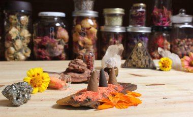 Incense Cones on Stone Slab With Chakra Crystals and Flowers