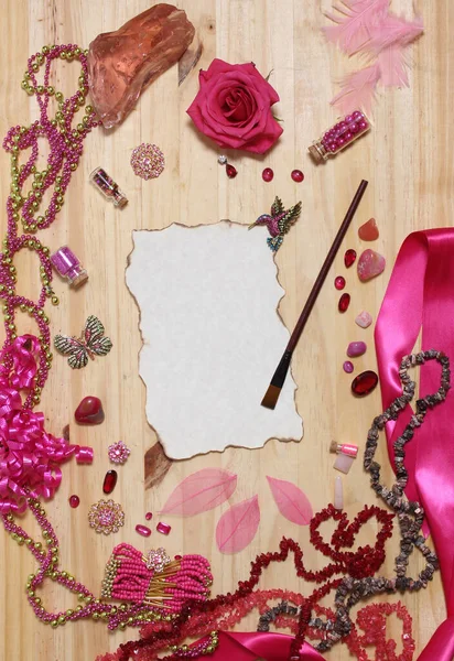 Pink and Magenta Jewelry With Flower and Paint Brush and Blank Paper With Burned Edges