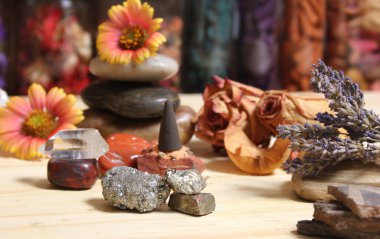Incense Cone on Stone Slab With Chakra Crystals and Flowers