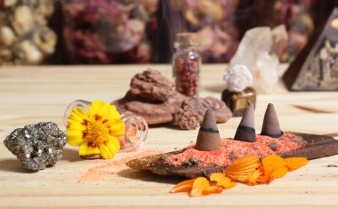 Incense Cones on Stone Slab With Chakra Crystals and Flowers