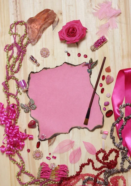 Pink and Magenta Jewelry With Flower and Paint Brush and Blank Paper With Burned Edges