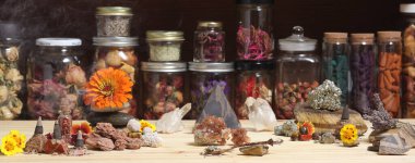 Meditation Altar With Rock Crystals and Flowers. Jars of Herbs in Background Shallow DOF