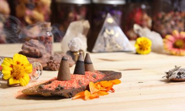 Incense Cones on Stone Slab With Chakra Crystals and Flowers