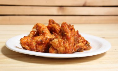 Fried Pork Skins With Red Salsa on Wooden Table in Rustic Kitchen