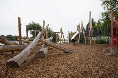 children's playground made of environment, eco-friendly materials. Wooden tree trunk sides, swings, net bridges, climbers. Beach number 2, Serebryany Bor (Silver Pinewood) forest park. Moscow, Russia